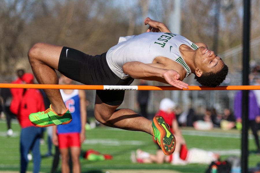 Daniel Robinson '24 leaps over the high jump bar during the Eastern Iowa Track and Field Festival on April 12.