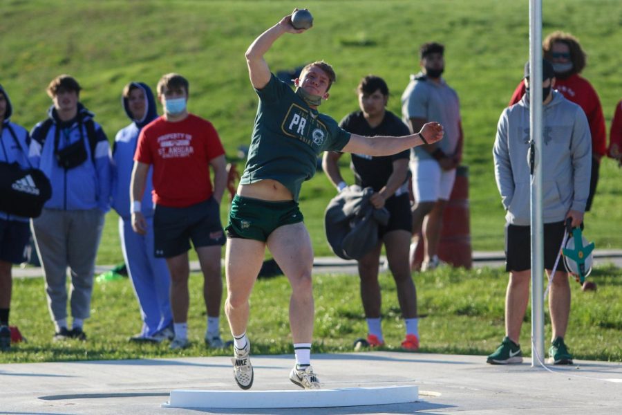 Will Towler '22 launches his shot put throw into the air during the Eastern Iowa Track and Field Festival on April 12.