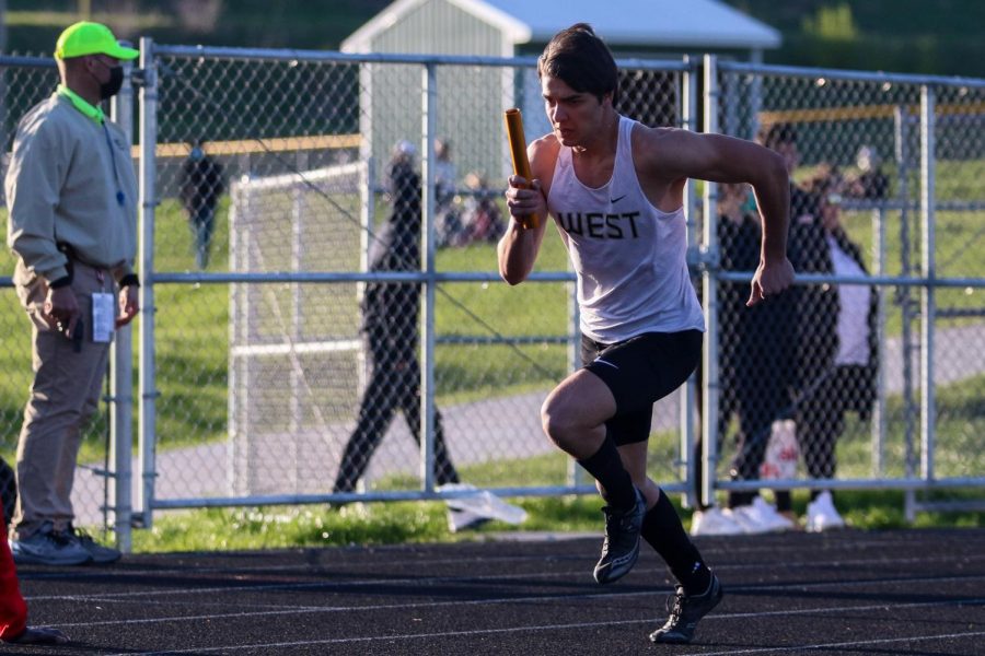 Nate Gudenkauf '22 flies off the blocks at the start of the 4 by 200 meter relay during the Eastern Iowa Track and Field Festival on April 12.