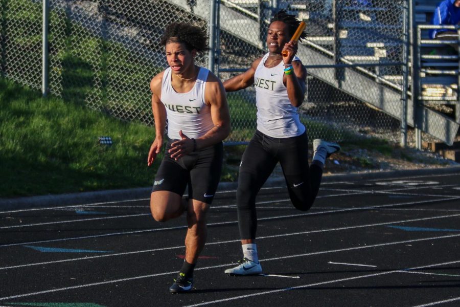 Fabian Brown '21 hands the baton off to Trey King '21 while running at the Eastern Iowa Track and Field Festival on April 12.