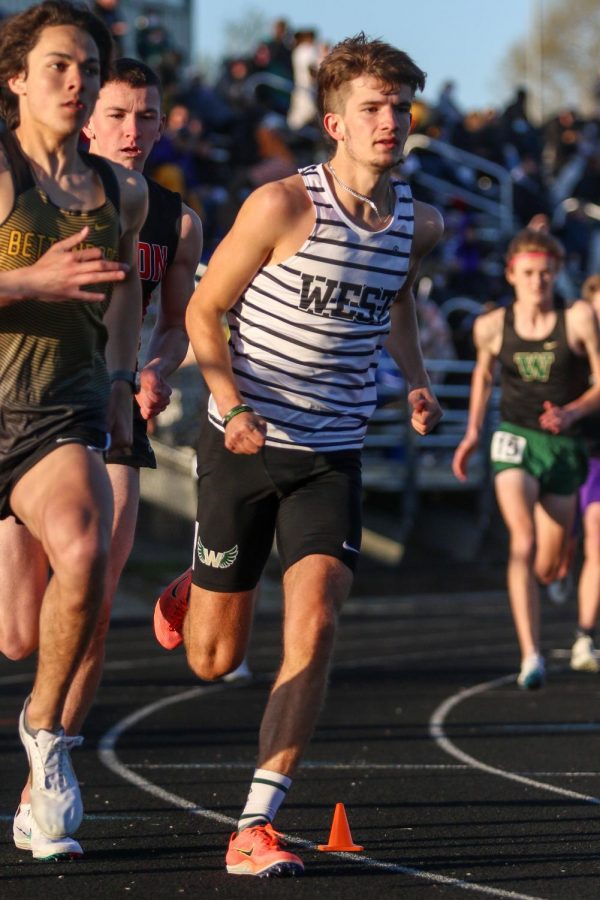 Caden Noeller '22 rounds the corner at the start of the 800 meter race during the Eastern Iowa Track and Field Festival on April 12.