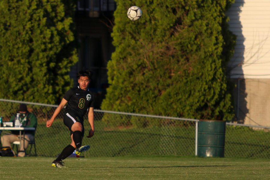 Andy Lu '21 lofts the ball into the air and over the keeper's head for a goal against Liberty on April 13.