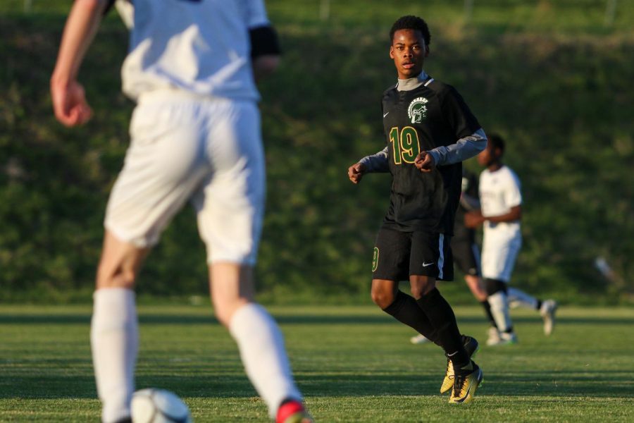 Ben Nkolobise '22 eyes the ball looking for a steal against Liberty on April 13.