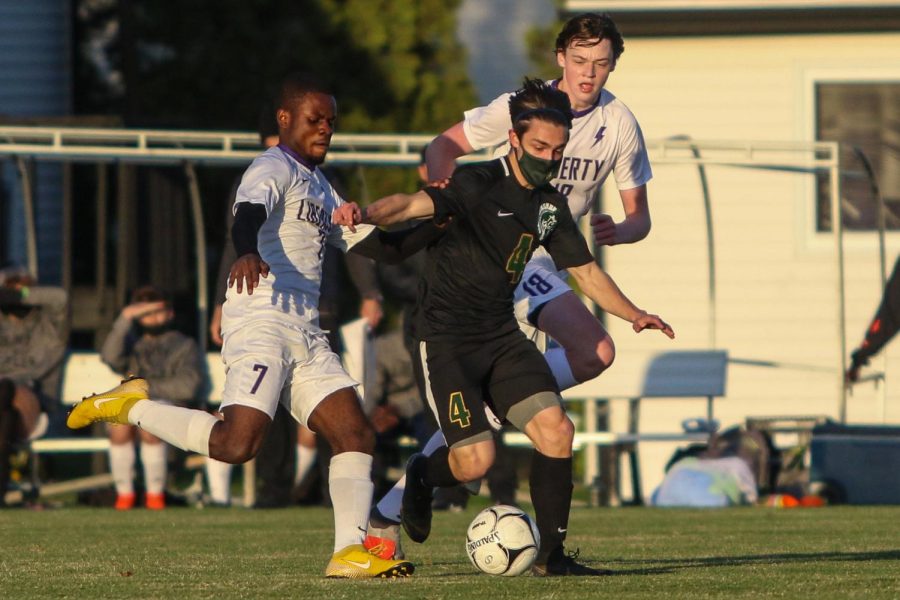 Miguel Cohen Suarez '22 fights for position and the ball against Liberty on April 13.