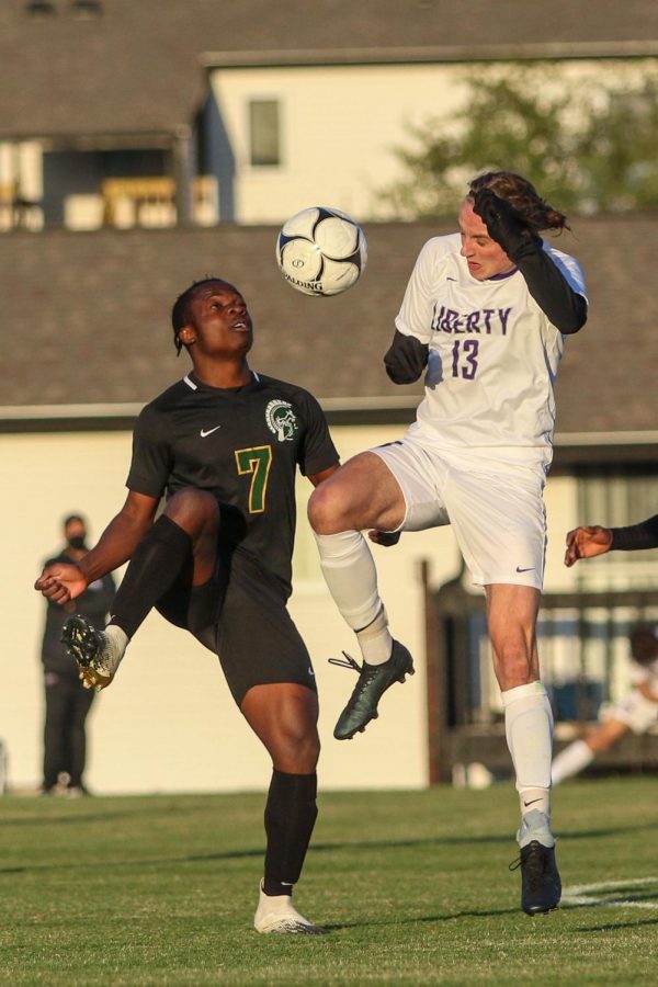 Marko Migambi '21 receives the ball in the box against Liberty on April 13.