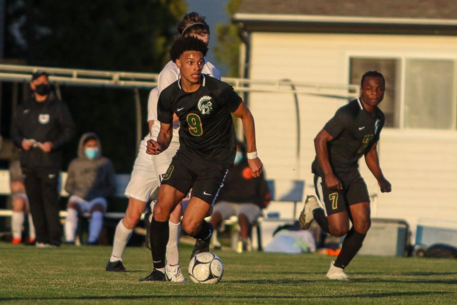 Kolby Godbolt '21 turns the corner looking to score against Liberty on April 13.