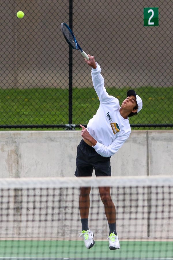 Luca Chackalackal '22 looks to score on a serve against Cedar Rapids Washington on April 14.