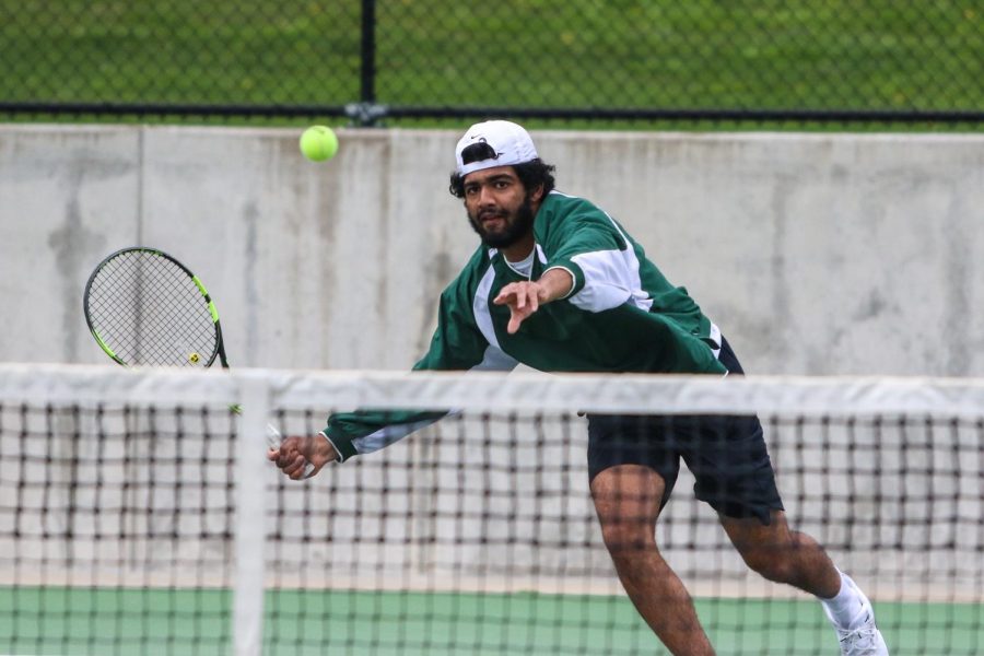 Mukundan Kasturirangan '21 looks to score while playing singles against Cedar Rapids Washington on April 14.