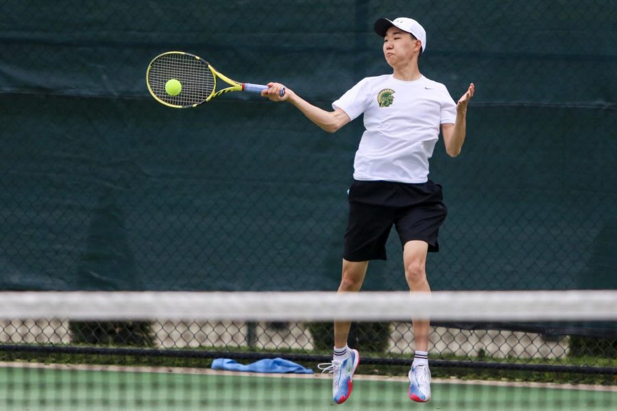 Jayden Shin '23 takes a forehand shot from the corner of the court while playing against Cedar Rapids Washington on April 14.