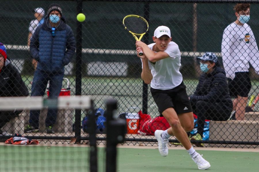 Eli Young '21 eyes the ball after his backhand shot against Cedar Rapids Washington on April 14.