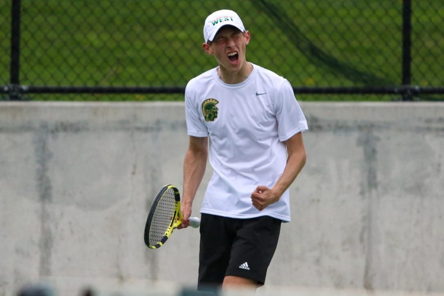 Eli Young '21 celebrates a point to win the set against Cedar Rapids Washington on April 14.