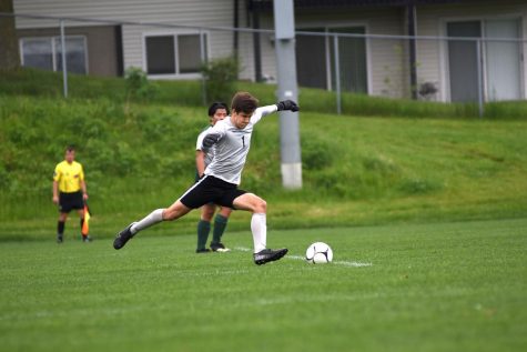 Keeper Nick McDonnell 22 puts the ball back into play as he defends the goal from North Scott. 