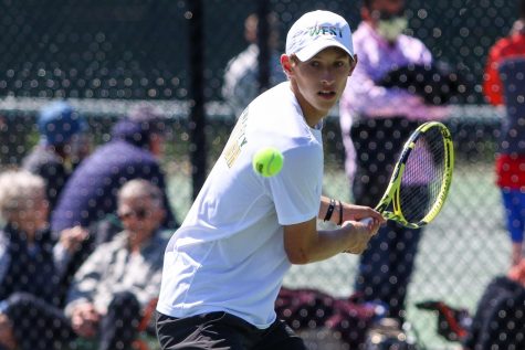 Eli Young 21 eyes the ball as he prepares to make a play while playing singles at the IHSAA Boys District Tennis tournament on May 12.