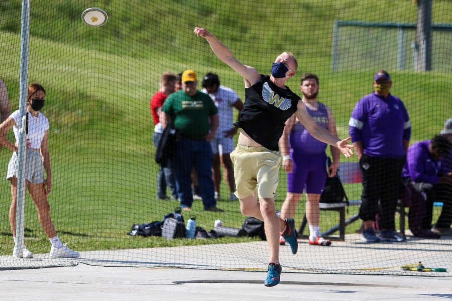 Tyler Halverson '21 launches the disk into the air while competing in the discus at the Class 4A district track and field meet on May 13.