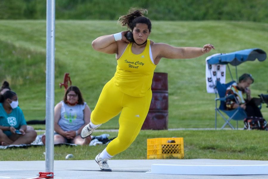 Phoebe Burt '21 winds up to throw the shot put at the Class 4A district track and field meet on May 13.