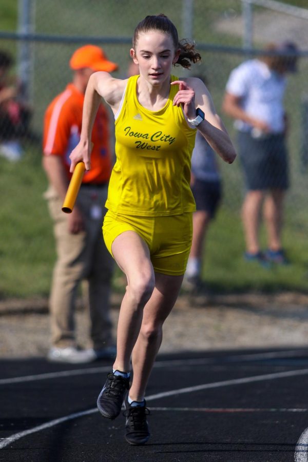 Annie Schwartz '23 strides out at the start of the 4 by 800-meter relay at the Class 4A district track and field meet on May 13.