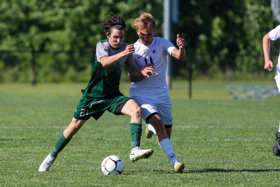 Michael Nelson '23 fights for possession against Pleasant Valley in the state championship game on June 5 in Des Moines.