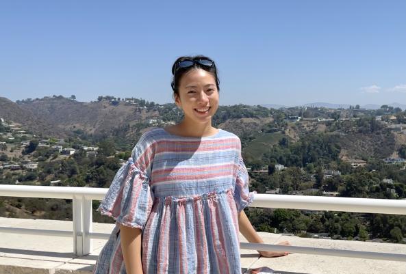 Maya Chu '23 is posing in front of a landscape during a trip. 