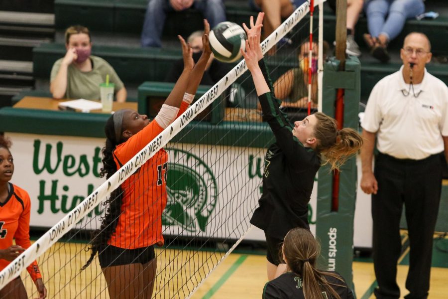 Raina Pfeifer '22 picks up a solo block against Waterloo East on Sept. 21.