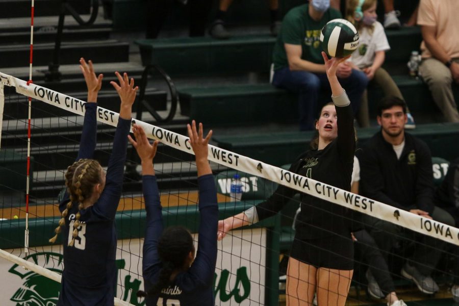 Emma Stammeyer '24 stares down the ball as she attempts to tip it over the net for a point against Xavier on Aug. 31. 