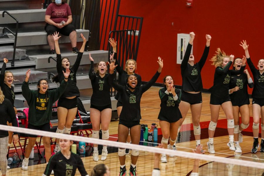 The bench celebrates a Sydney Woods '22 kill during the Battle for the Spike at City High on Sept. 30.