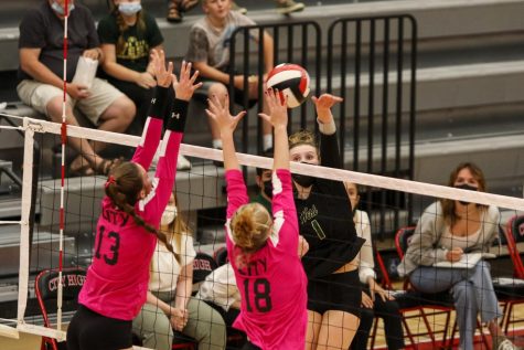 Emma Stammeyer 24 attempts to hit the ball past two City High blockers during the Battle for the Spike at City High on Sept. 30.