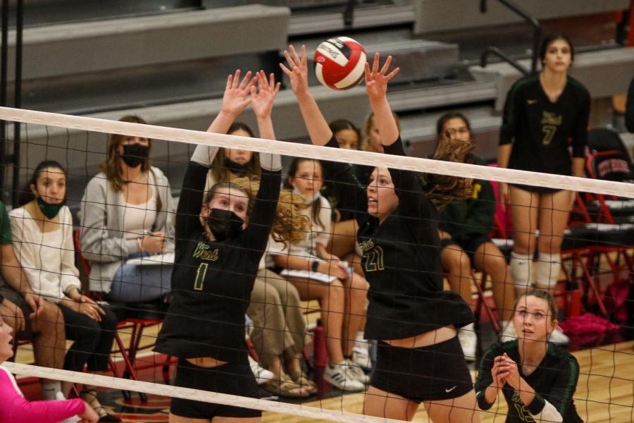 Emma Stammeyer '24 and Carmen Crabtree '22 reach for a block during the Battle for the Spike at City High on Sept. 30.