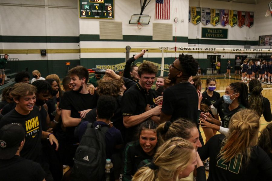 The student section and volleyball team celebrate on the edge of the court after after defeating Xavier on Aug. 31.