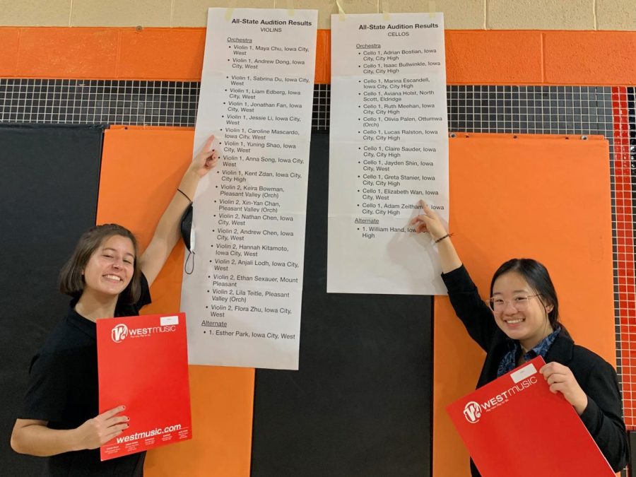 Seniors Caroline Mascardo and Elizabeth Wan point to their names on the accepted musicians list.