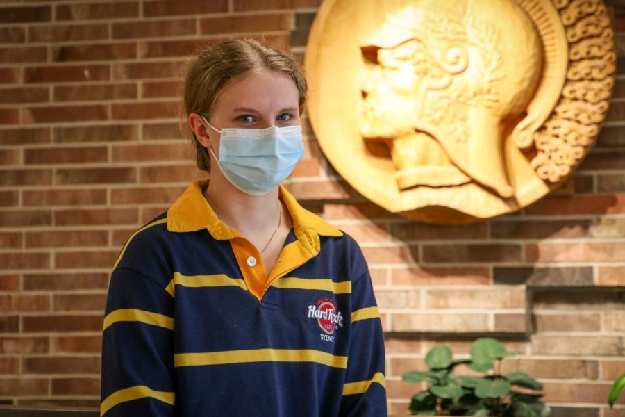 Laney Prelle '22 poses in front of her new school's mascot.