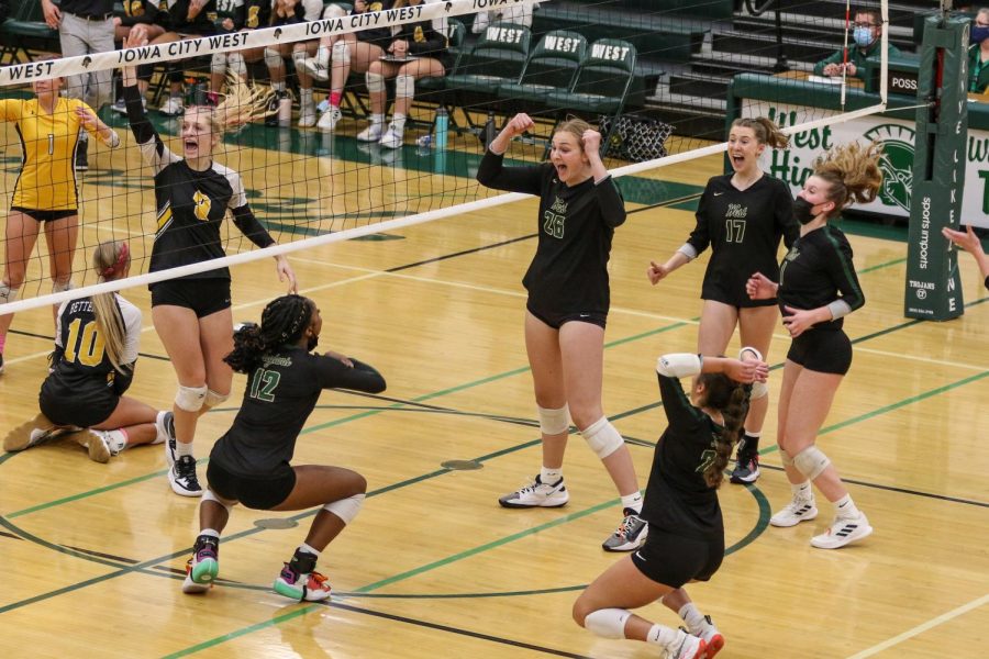 Sophia Deyak '23 and Melae' Lacy '24 celebrate the match point on Oct. 21 during the regional semifinal against Bettendorf.