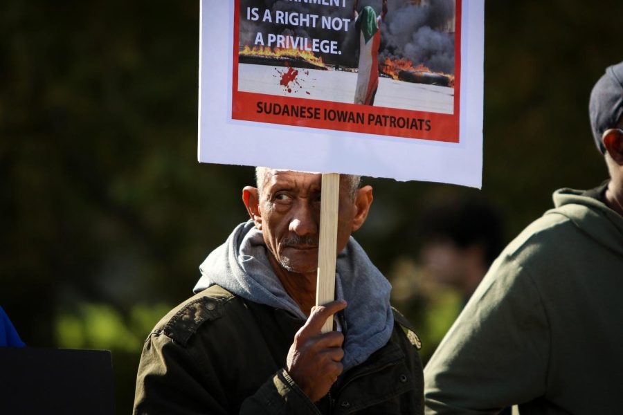 A man looks on as the protest against the military coup in Sudan starts to grow at the Pentacrest in downtown Iowa City on Oct. 30. 