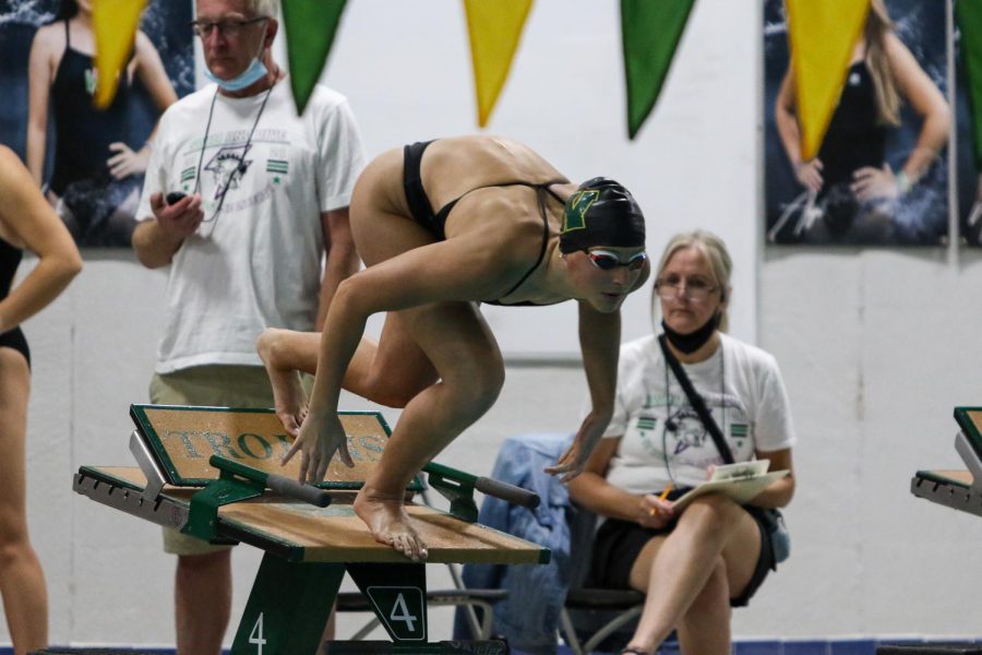 Scarlet Martin '22 gets ready to dive in at the start of the 100 yard freestyle on Oct. 19 during a dual meet against City High.