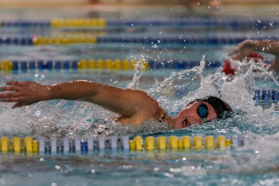 Olivia Taeger '22 takes a breath while swimming in the 500 yard freestyle on Oct. 19 during a dual meet against City High.