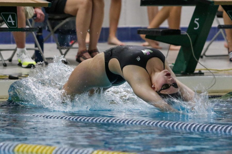 Carlee Wilkins '24 flies off the wall at the start of the 100 yard backstroke on Oct. 19 during a dual meet against City High.