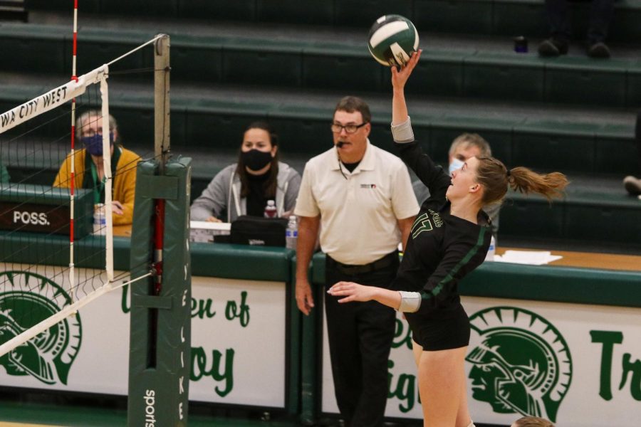 Raina Pfeifer '22 looks to get a kill as she hits the ball over the net on Oct. 21 during the regional semifinal against Bettendorf.