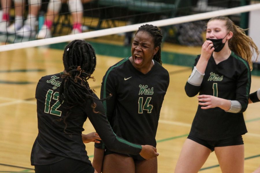 Mayowa+Dokun+22+celebrates+a+kill+with+Melae+Lacy+24+on+Oct.+21+during+the+regional+semifinal+against+Bettendorf.