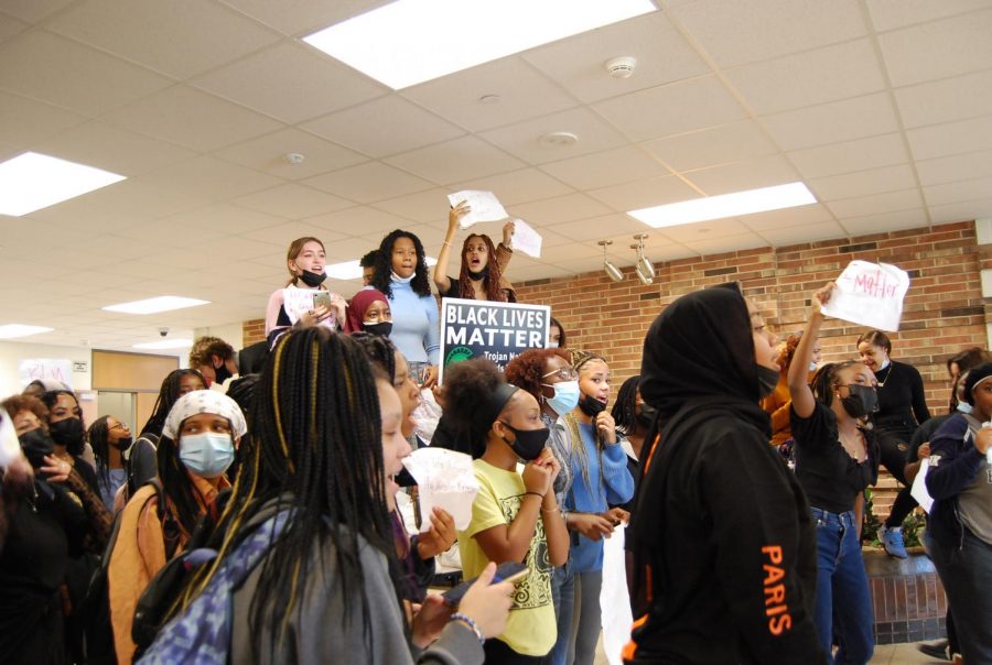 Student chanting and holding signs in the commons area at West High.