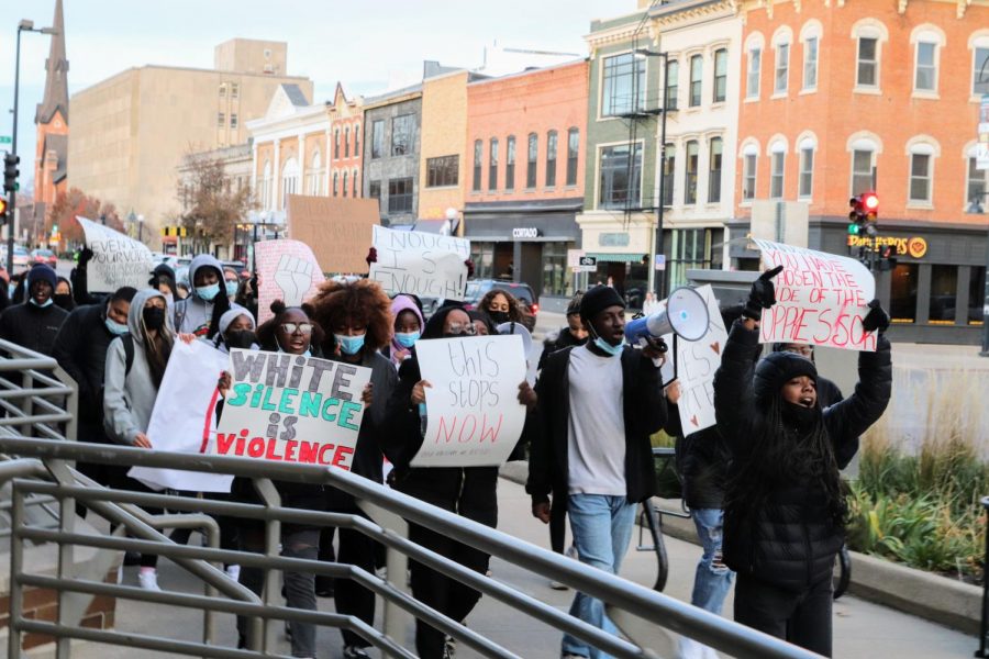 Protesters march through Iowa City chanting, Whose schools? Our schools,