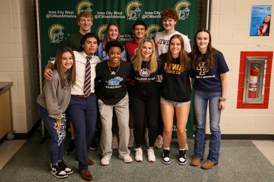 All ten Trojan athletes that participated in the signing ceremony after school pose for a picture in the cafeteria on Nov. 10.