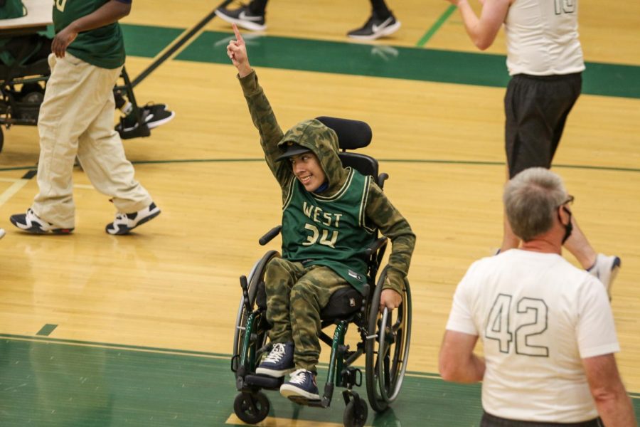 Jordan Caperon 23 celebrates a Kerry Wang 25 bucket during the PALS and Community Inclusion Clubs annual basketball game against the faculty on Nov. 11.