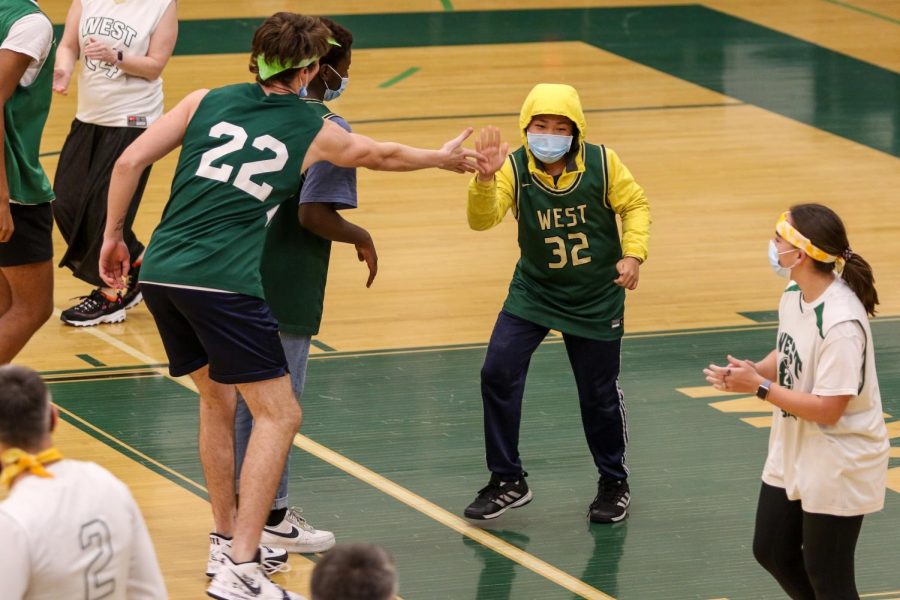 Kerry Wang '25 celebrates a Pete Moe '22 dunk during the PALS and Community Inclusion Club's annual basketball game against the faculty on Nov. 11.