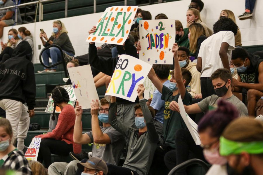 Students hold up signs in support of the PALS and Community Inclusion Club team during their annual basketball game against the faculty on Nov. 11.