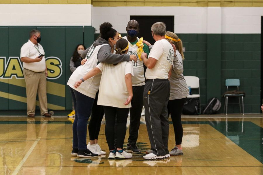The faculty team huddles up before the start of the PALS and Community Inclusion Clubs annual basketball game against the faculty on Nov. 11.