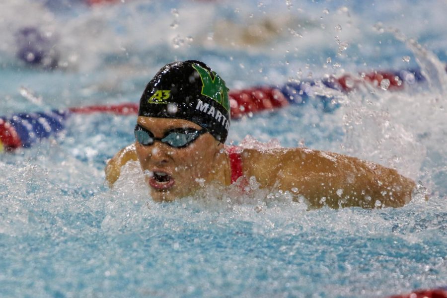 Scarlet Martin 22 takes a breath while swimming the 100 yard butterfly during the IGHSAU State Swimming and Diving Championships in Marshalltown on Nov. 13.