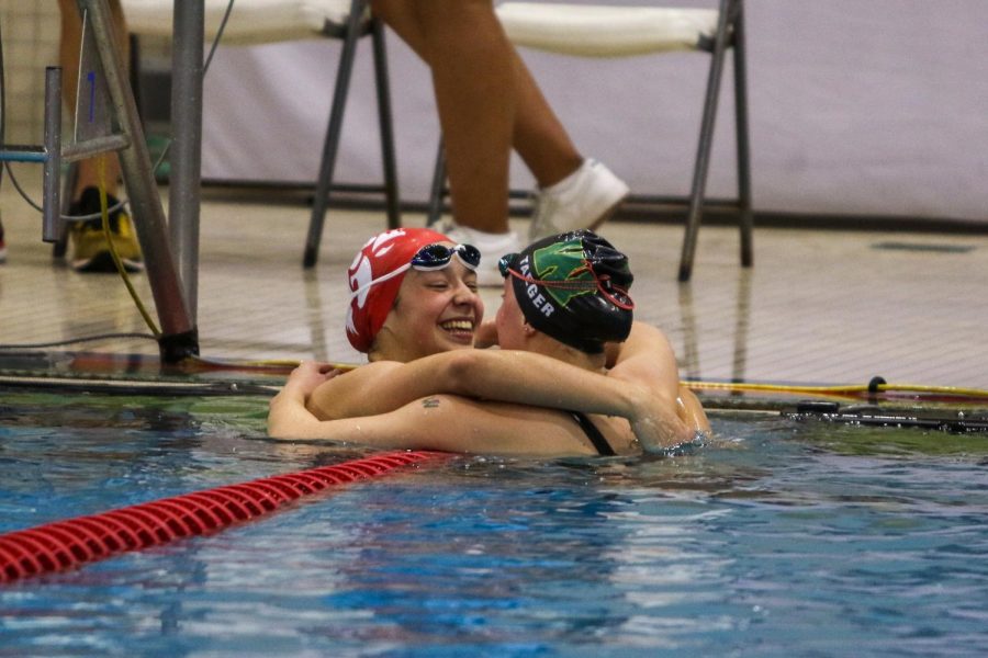 City High's Grace Hoeper '25 and Olivia Taeger '22 congratulate each other after the 100 yard freestyle during the IGHSAU State Swimming and Diving Championships in Marshalltown on Nov. 13.