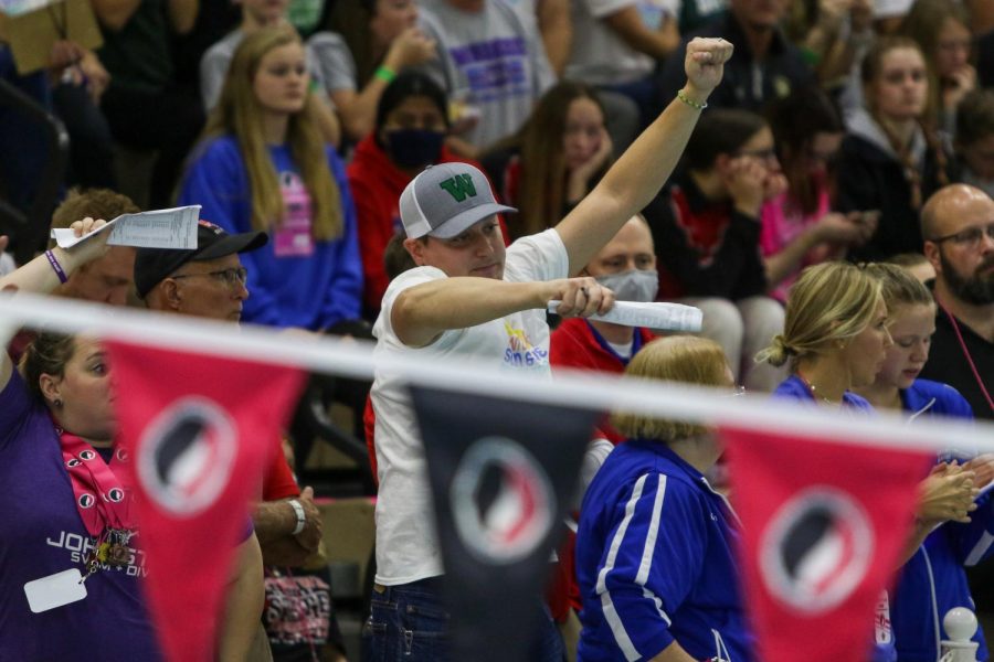 Head Coach Byron Butler cheers on his swimmers from the pool deck during the IGHSAU State Swimming and Diving Championships in Marshalltown on Nov. 13.