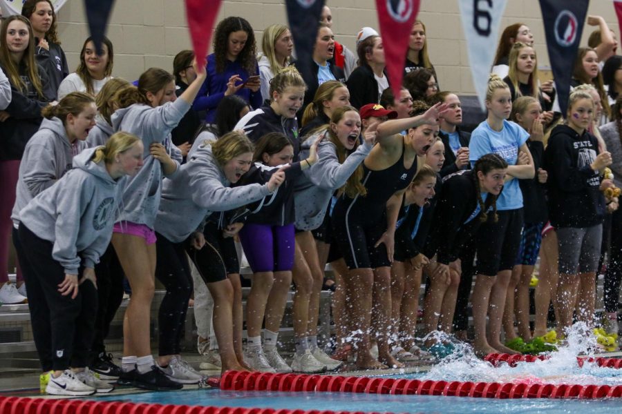The Trojan Bolts cheer on the 400 yard freestyle relay team during the IGHSAU State Swimming and Diving Championships in Marshalltown on Nov. 13.