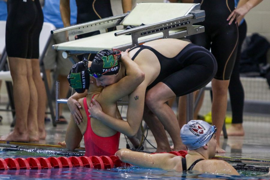 Scarlet Martin '22 and Olivia Taeger '22 hug after finishing their high school swimming careers during the IGHSAU State Swimming and Diving Championships in Marshalltown on Nov. 13.