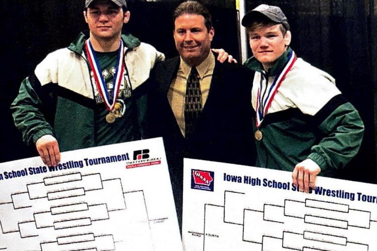 Coach+Mark+Reiland+with+Nelson+Brands+18+and+Francis+Duggan+18+at+the+2018+Wrestling+State+Championship.+Both+Brands+and+Duggan+won+titles.